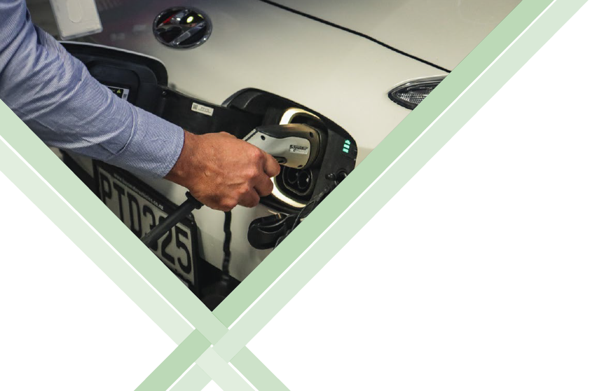 Hand recharges an electric vehicle